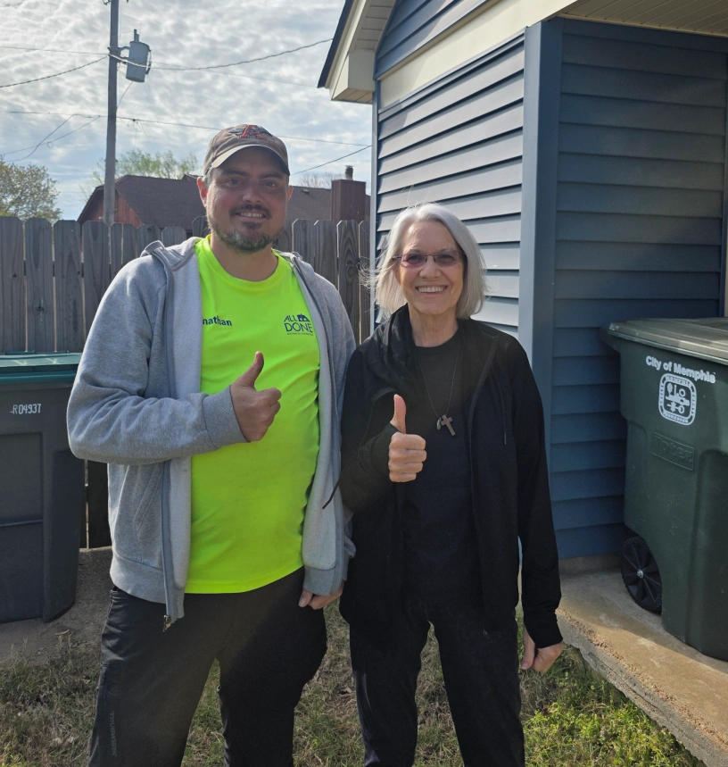 Jonathan Stephenson with a homeowner after finishing a job in Memphis, Tennessee